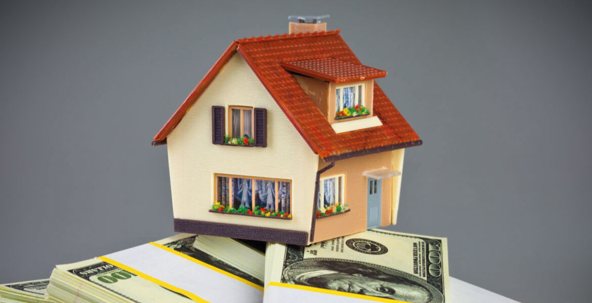 Concept of real estate investment with a model house on packs of banknotes - 6 Benefits Of Investing In Real Estate - DG Pinnacle Commercial - Miami Real Estate Investor