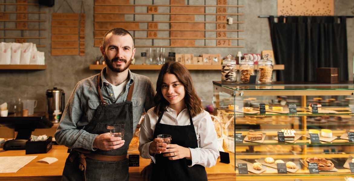 Young couple of independent workers in their own coffee-shop | Mortgage Loans Your Self-Employed Customers | DG Pinnacle Commercial - Miami Mortgage Lender